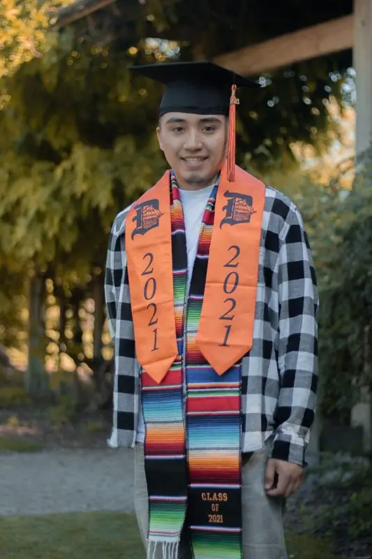 Graduate with class of 2021 sash