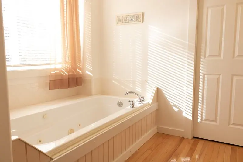 Bathroom with a sunlit corner tub