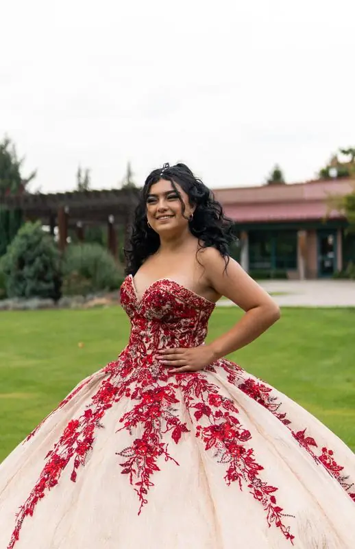 Young woman in a red and beige ball gown