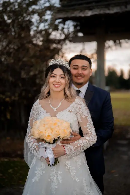 Bride and groom posing outdoors