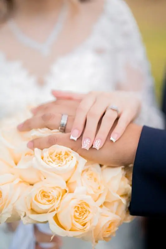 Wedding rings resting on a bouquet