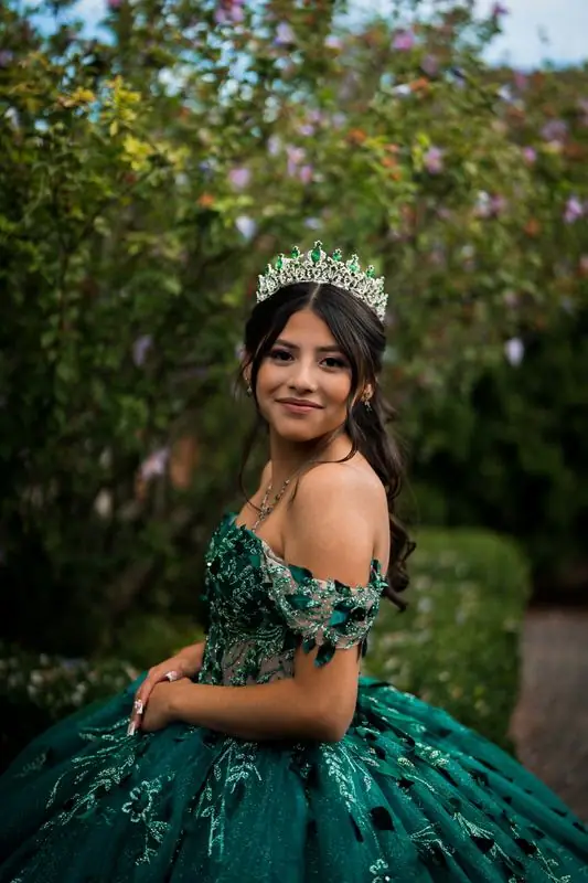 Young woman in a green formal gown and tiara