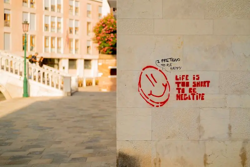 Graffiti reading Life is too short to be negative