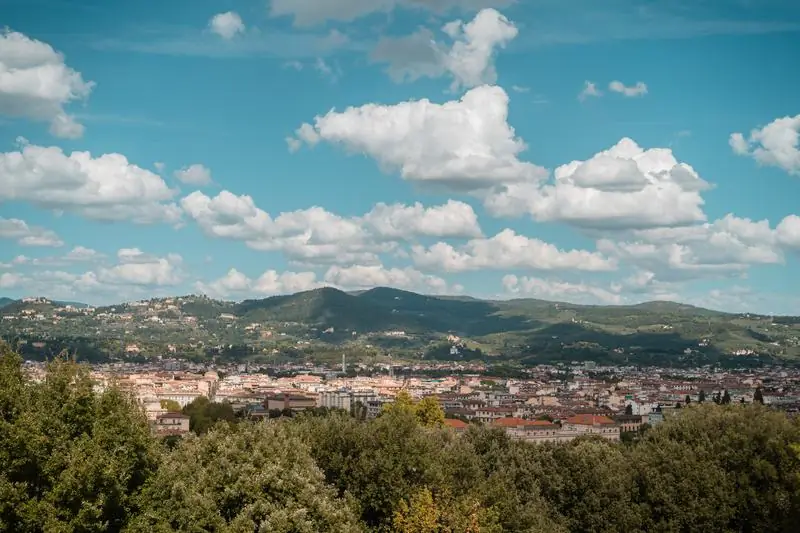 Red-roofed city among green hills