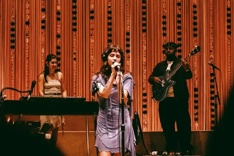 Singer with headphones and band