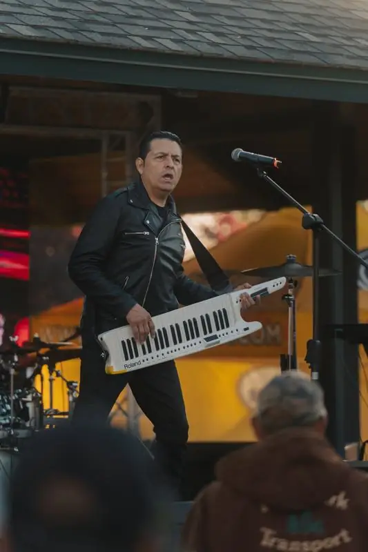 Man playing a keytar on stage