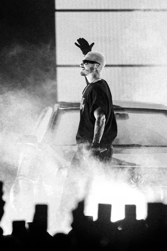 Black and white artist next to an open car door