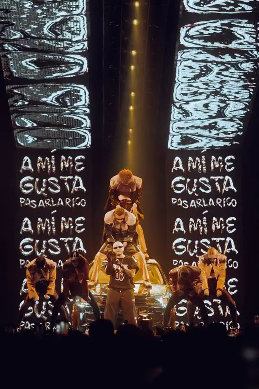 Performers stacked on and around a car