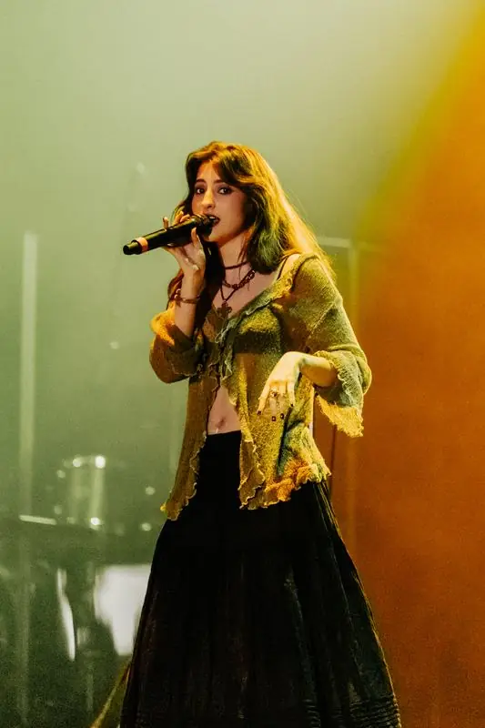 Singer with green and yellow lighting