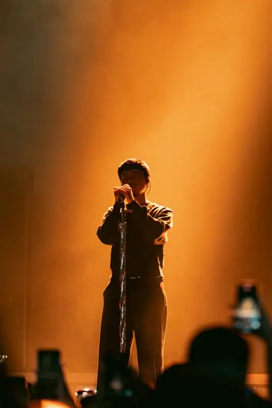 Singer in warm orange light