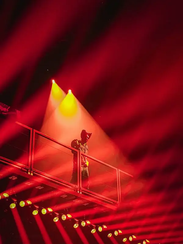 Performer with red and orange lighting